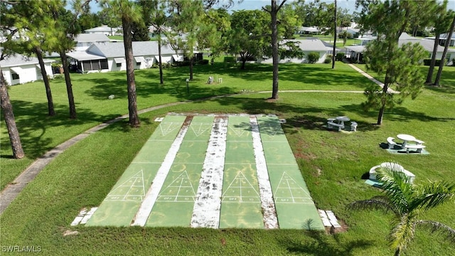 view of home's community with a lawn