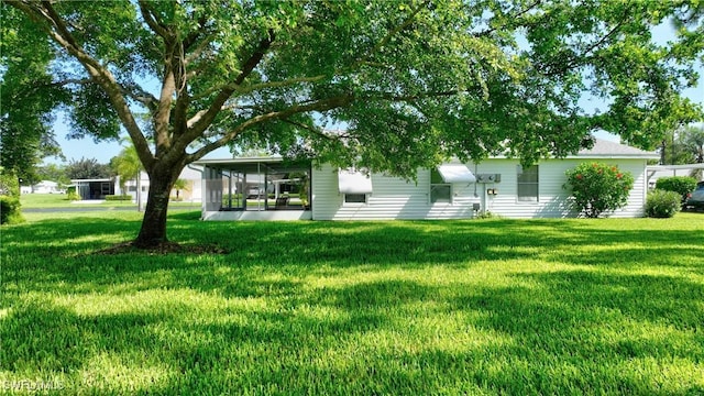 view of yard featuring a sunroom