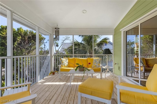 sunroom / solarium featuring vaulted ceiling and a wealth of natural light