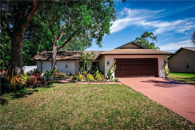 ranch-style home with driveway, a front yard, a garage, and stucco siding