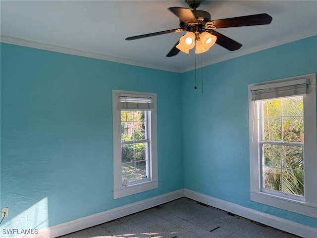 spare room with ornamental molding and ceiling fan