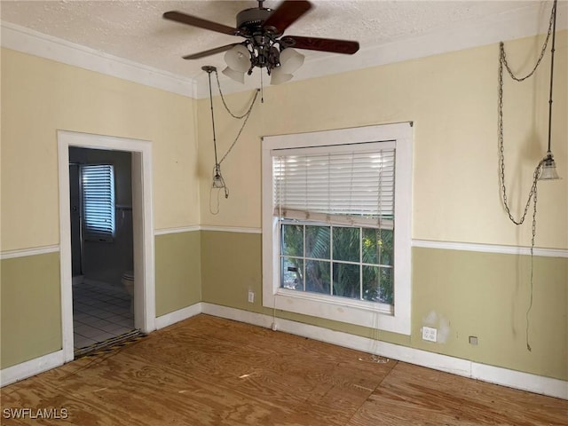 empty room with hardwood / wood-style flooring, ceiling fan, and a textured ceiling