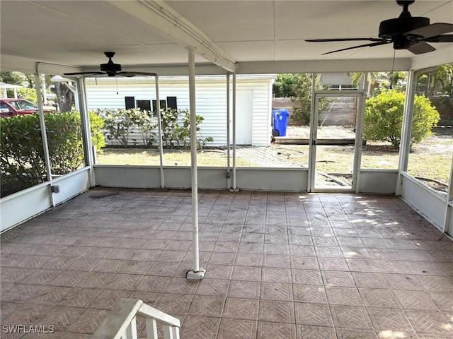 unfurnished sunroom featuring a wealth of natural light and ceiling fan