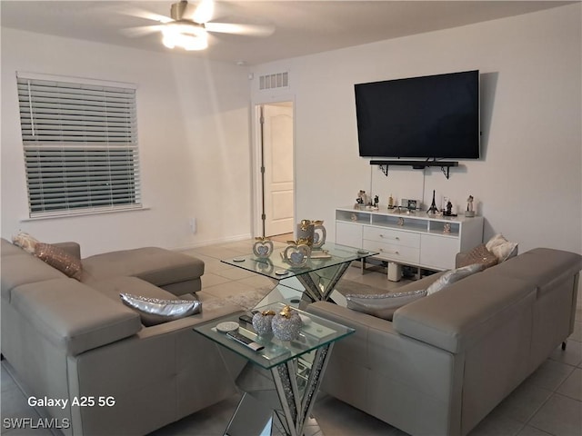 tiled living room featuring ceiling fan