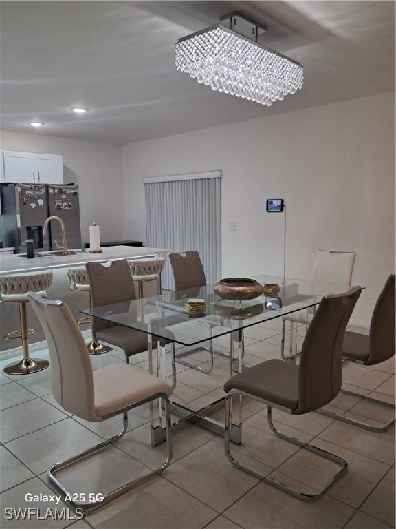 tiled dining space with a chandelier