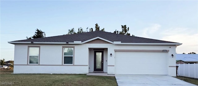 ranch-style house with a garage and a front yard