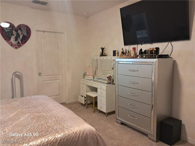 bedroom featuring light carpet