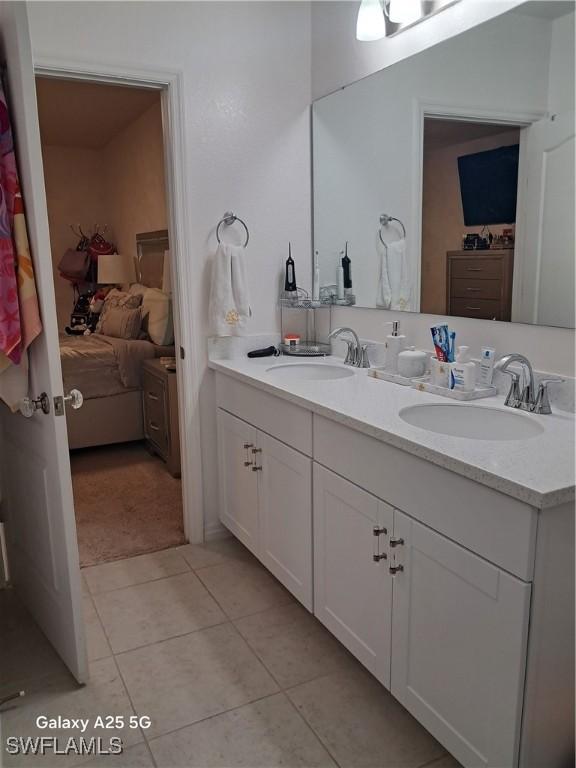 bathroom featuring tile patterned flooring and vanity