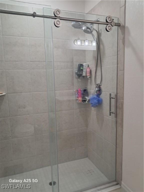 bathroom featuring a shower with door