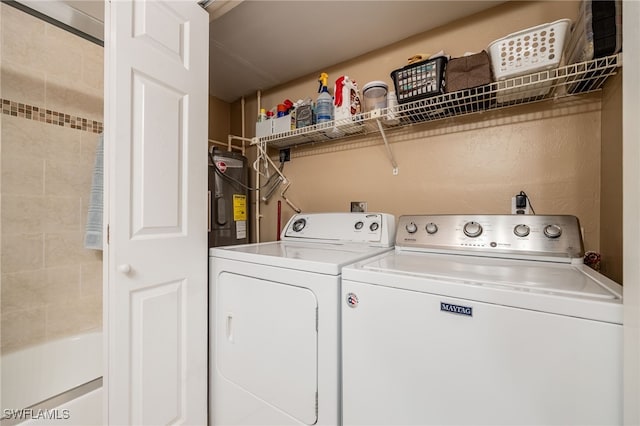 902 SW 48th Ter Unit 104, Cape Coral, FL 33914 - laundry area featuring electric water heater and washer and clothes dryer