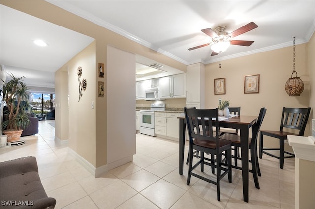 902 SW 48th Ter Unit 104, Cape Coral, FL 33914 - dining room featuring a ceiling fan, baseboards, light tile patterned floors, and ornamental molding