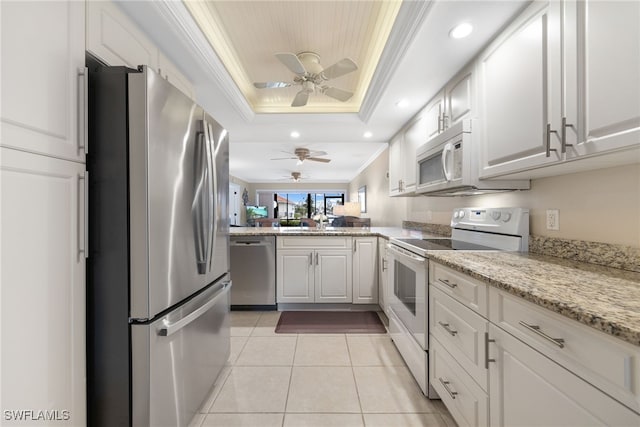 902 SW 48th Ter Unit 104, Cape Coral, FL 33914 - kitchen featuring stainless steel appliances, a raised ceiling, ornamental molding, a ceiling fan, and light tile patterned floors