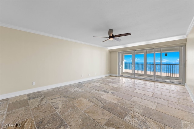 empty room featuring crown molding, ceiling fan, and a water view