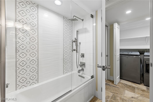 bathroom featuring washing machine and clothes dryer and combined bath / shower with glass door