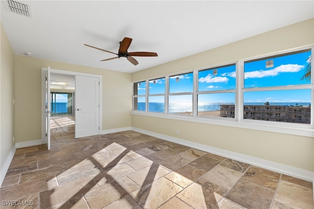 interior space with a water view and ceiling fan