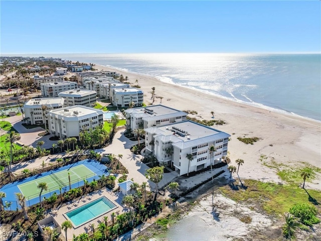 bird's eye view with a water view and a beach view