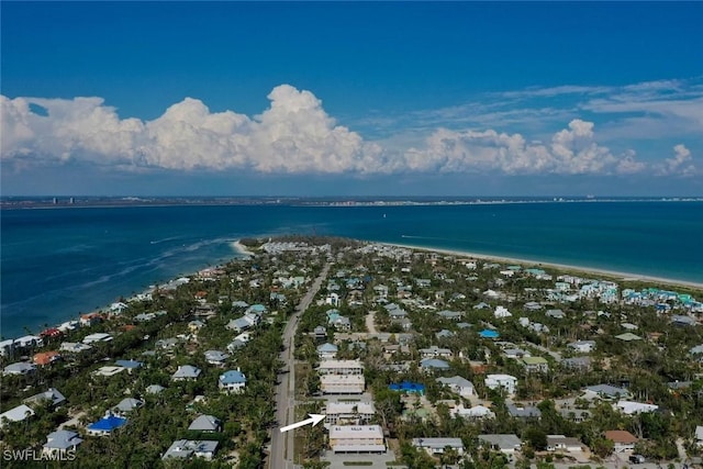 birds eye view of property with a water view and a beach view