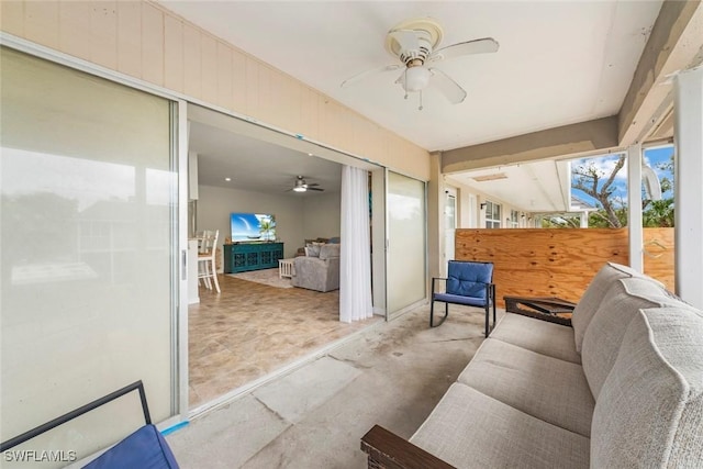 sunroom / solarium featuring ceiling fan