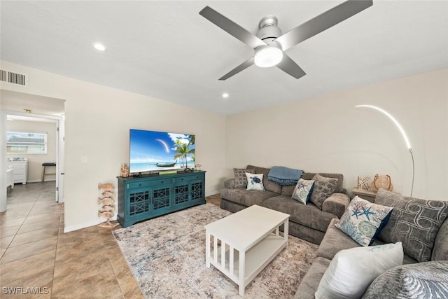 tiled living room with ceiling fan