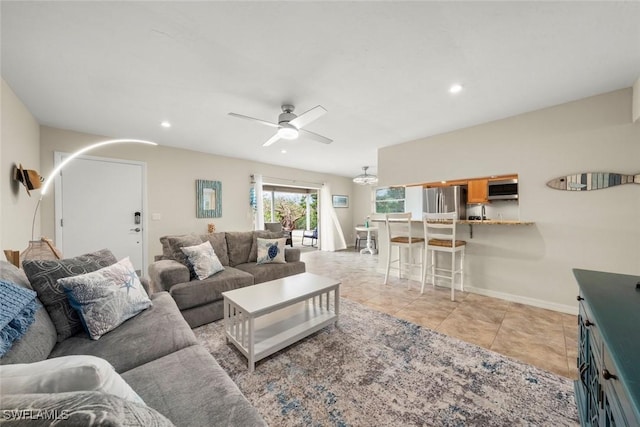 living room with ceiling fan and light tile patterned flooring