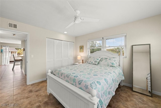 bedroom featuring tile patterned floors, ceiling fan, and a closet