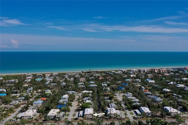 drone / aerial view with a beach view and a water view