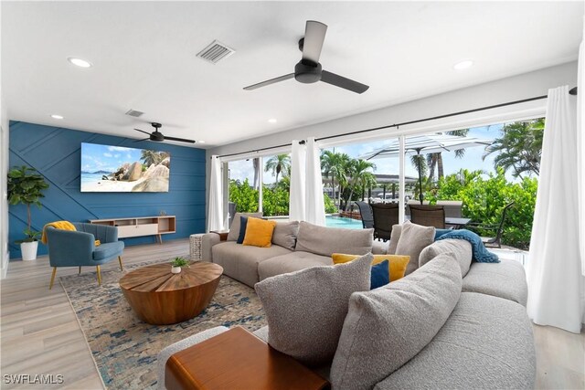 living room with ceiling fan and light wood-type flooring