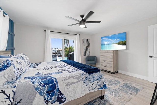 bedroom featuring access to outside, light hardwood / wood-style floors, and ceiling fan