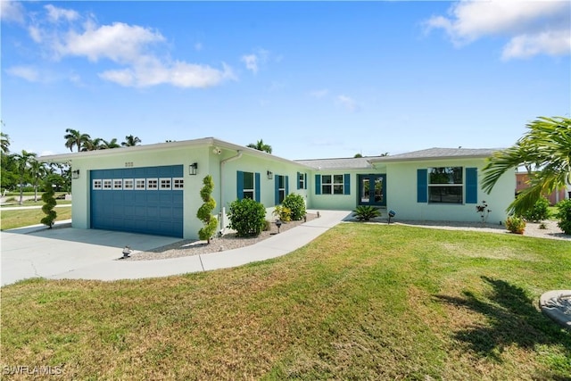 ranch-style home with a garage and a front lawn