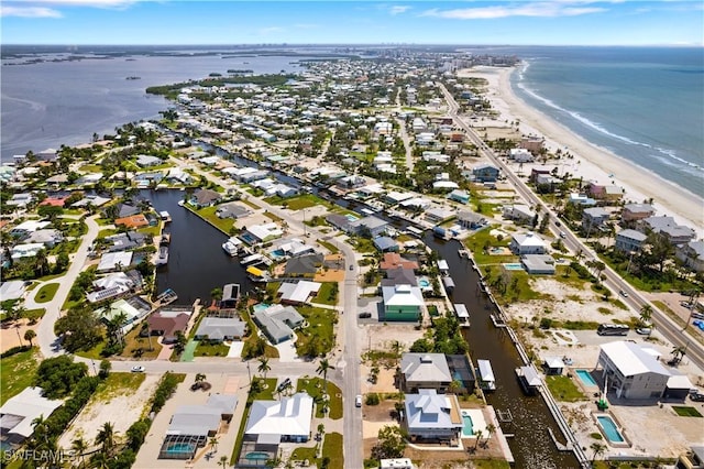 bird's eye view featuring a water view and a beach view