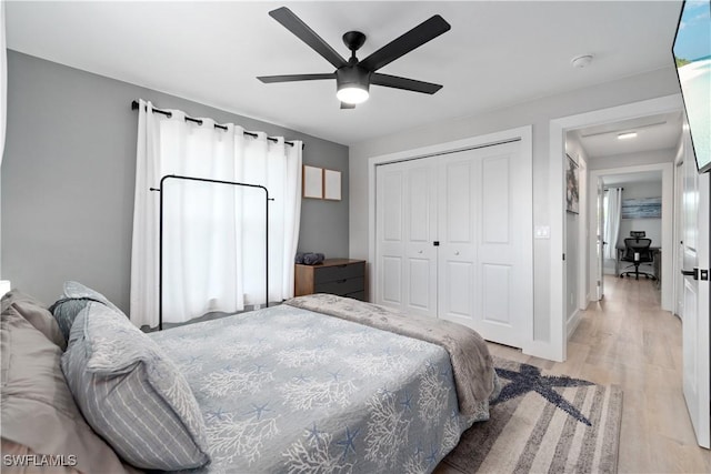 bedroom with a closet, ceiling fan, and light wood-type flooring