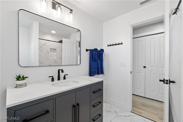 bathroom featuring vanity and a shower