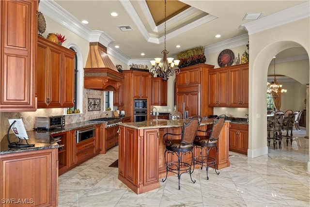 2704 Shriver Dr, Fort Myers, FL 33901 - kitchen featuring visible vents, arched walkways, a notable chandelier, and built in appliances