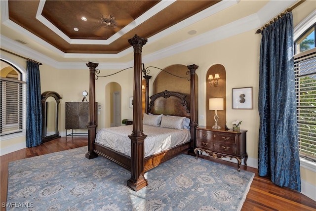 2704 Shriver Dr, Fort Myers, FL 33901 - bedroom featuring arched walkways, visible vents, a raised ceiling, wood finished floors, and crown molding