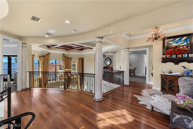 2704 Shriver Dr, Fort Myers, FL 33901 - corridor with decorative columns, wood finished floors, an upstairs landing, and a notable chandelier