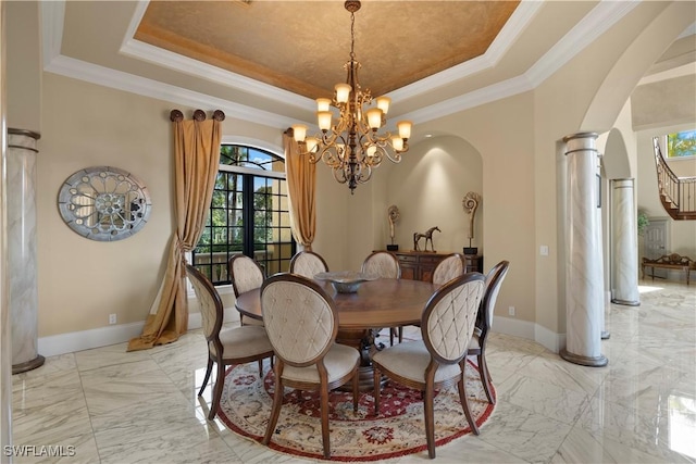 2704 Shriver Dr, Fort Myers, FL 33901 - dining area featuring baseboards, arched walkways, marble finish floor, a tray ceiling, and crown molding