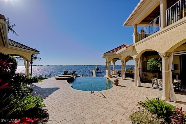 2704 Shriver Dr, Fort Myers, FL 33901 - view of swimming pool featuring a water view, a pool with connected hot tub, and a patio