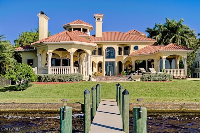 2704 Shriver Dr, Fort Myers, FL 33901 - rear view of house featuring a tile roof, a yard, and a water view