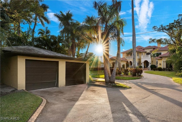 2704 Shriver Dr, Fort Myers, FL 33901 - view of front facade featuring a garage, an outbuilding, and stucco siding