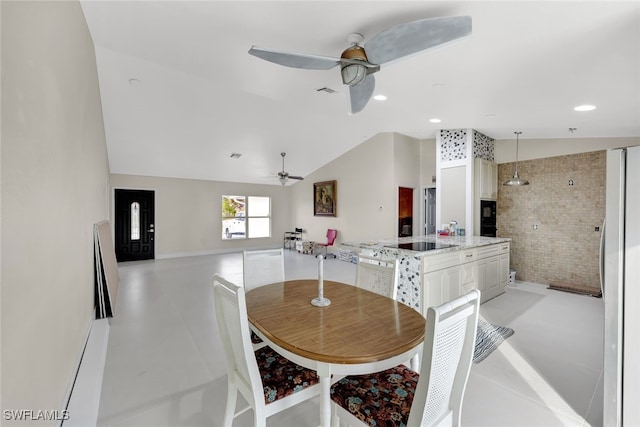 dining room featuring ceiling fan, brick wall, and lofted ceiling