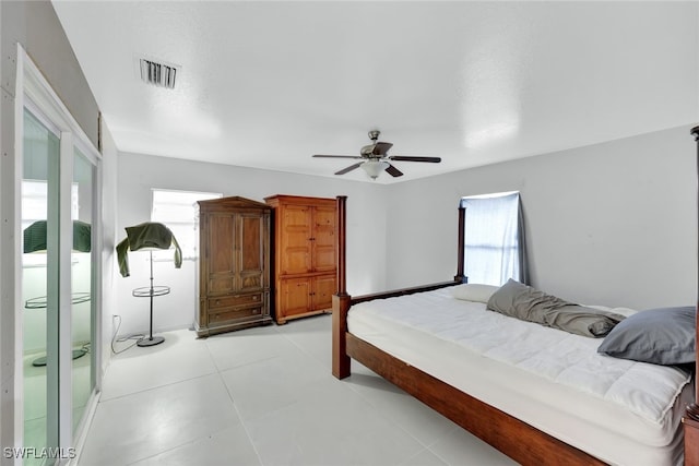 tiled bedroom featuring ceiling fan