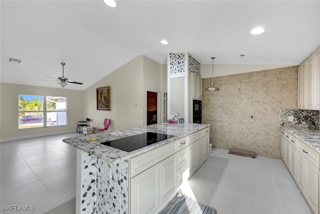 kitchen featuring black appliances, decorative light fixtures, light stone countertops, and vaulted ceiling