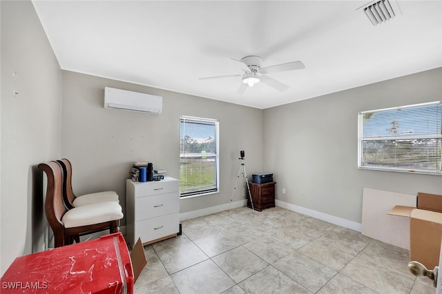 living area with ceiling fan, a wall mounted AC, and light tile patterned flooring