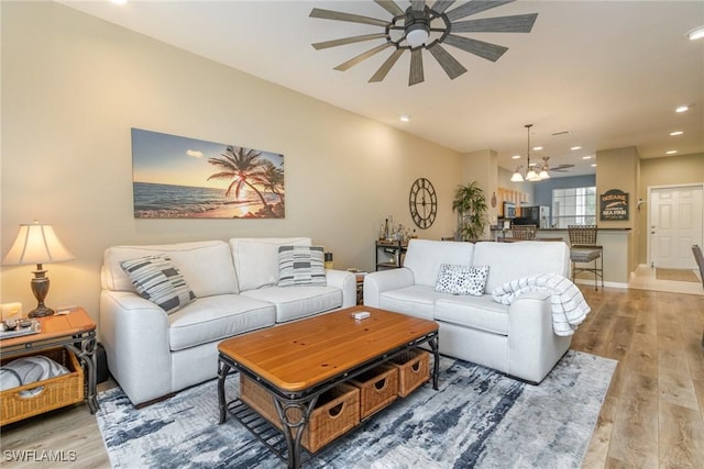 living room featuring ceiling fan and light wood-type flooring