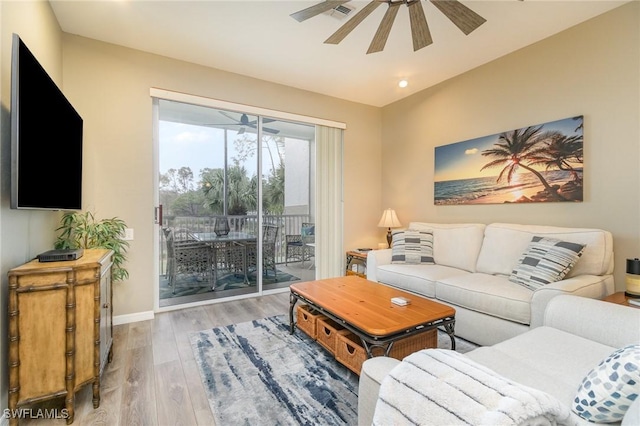 living room with hardwood / wood-style flooring and ceiling fan