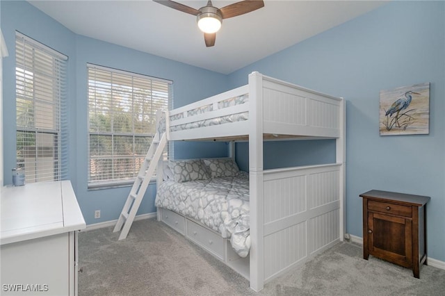 bedroom with ceiling fan and light carpet