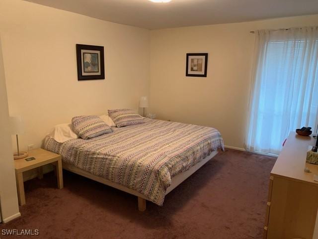 bedroom featuring dark colored carpet