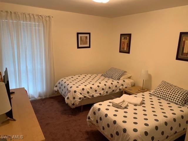 bedroom featuring dark colored carpet