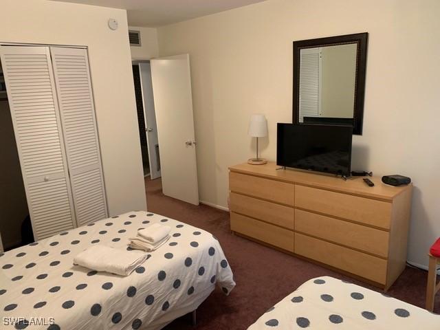 carpeted bedroom featuring a closet