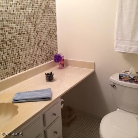 bathroom with tile patterned floors, vanity, and toilet